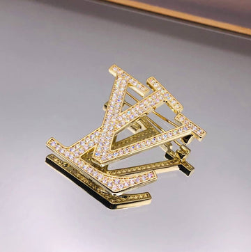 Broche LV doré